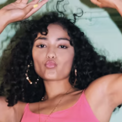 Curly-haired woman posing